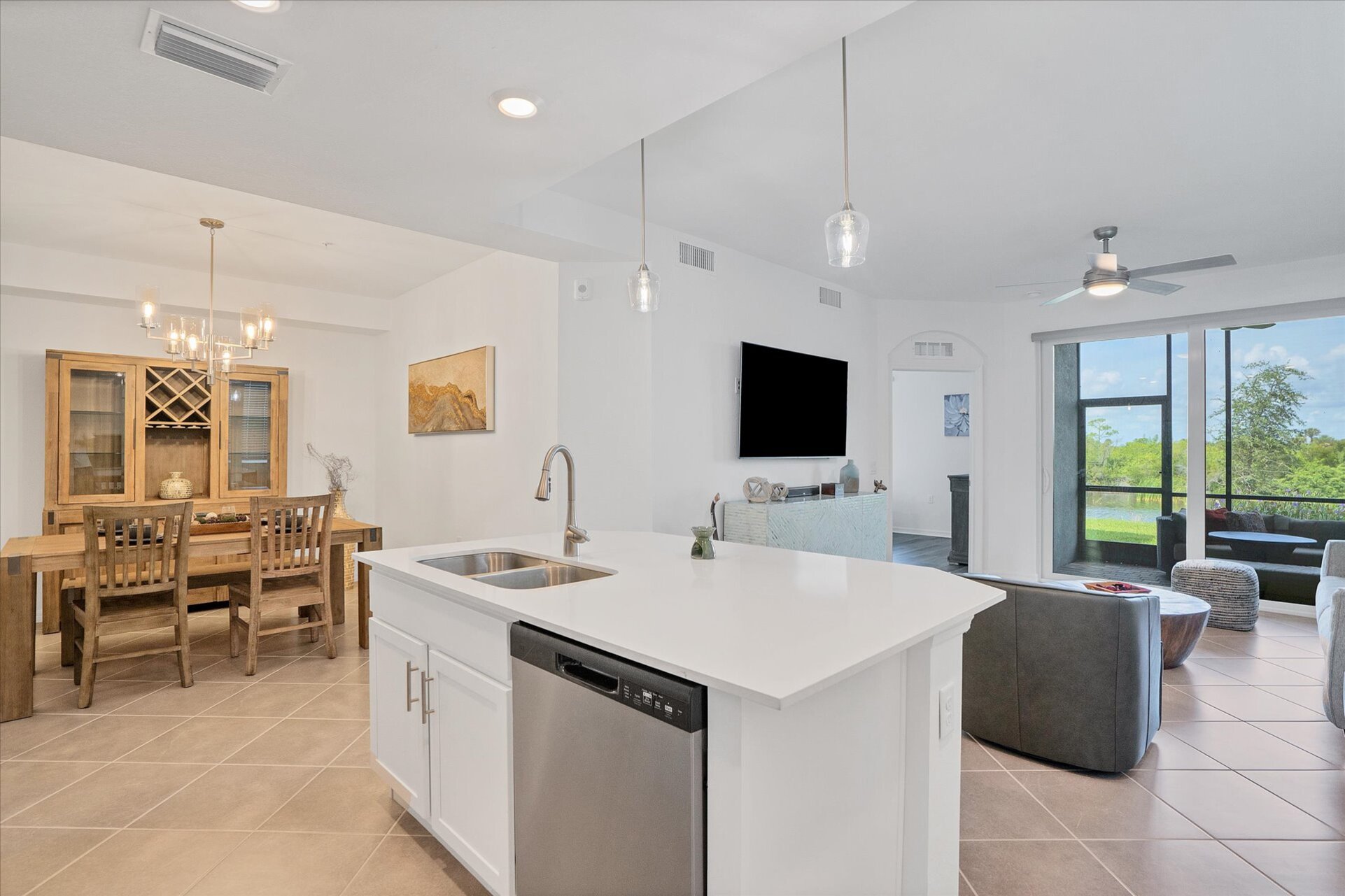 Bright, fully-equipped kitchen overlooking dining room & living room. Kitchen island seats 2