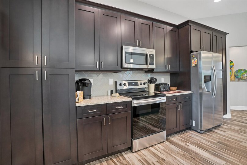 Gorgeous, fully-equipped kitchen featuring stainless steel appliances, and huge kitchen island that seats 4