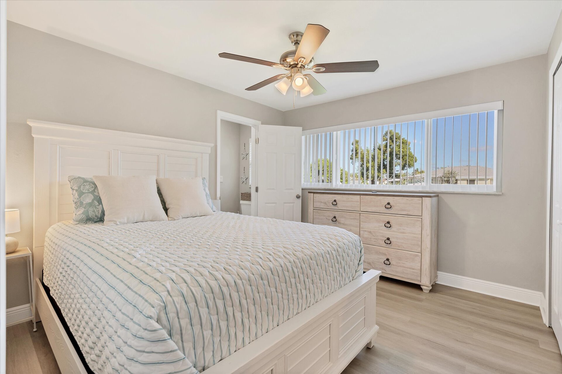 Guest bedroom 1 with queen bed and attached half bathroom