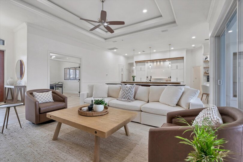 Beautiful open living area with ample seating, 65-inch Smart TV & dining table that converts to a tavern shuffleboard table