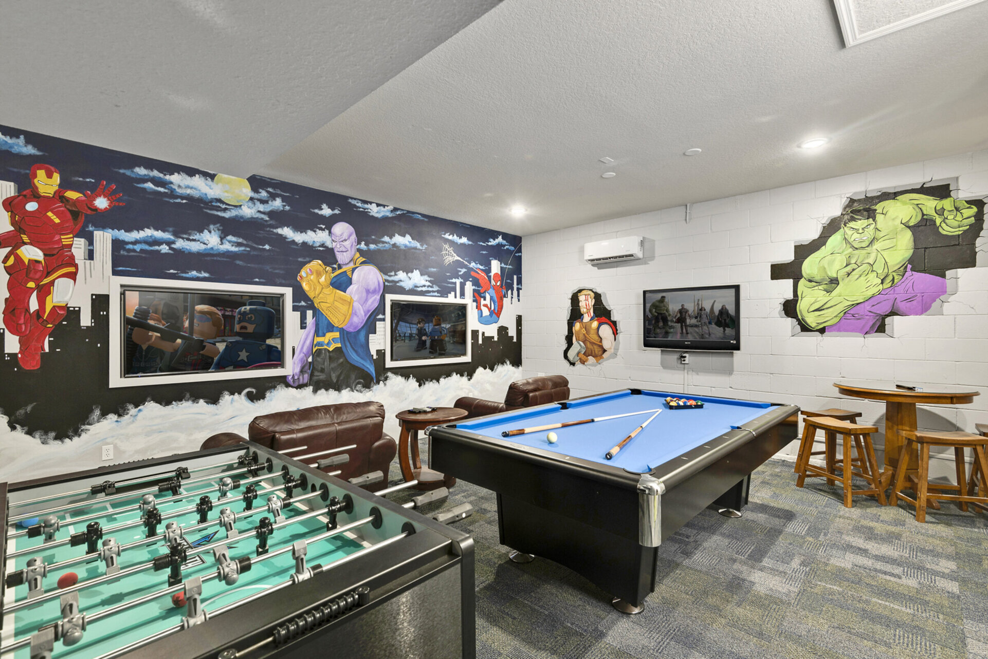 Featuring a foosball table, pool table, gaming system and table and chairs