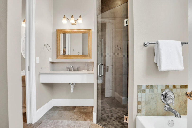 The en-suite includes a walk in shower and garden tub