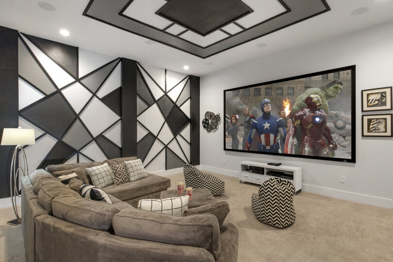 Modern meets retro in this theater room with a large projection screen