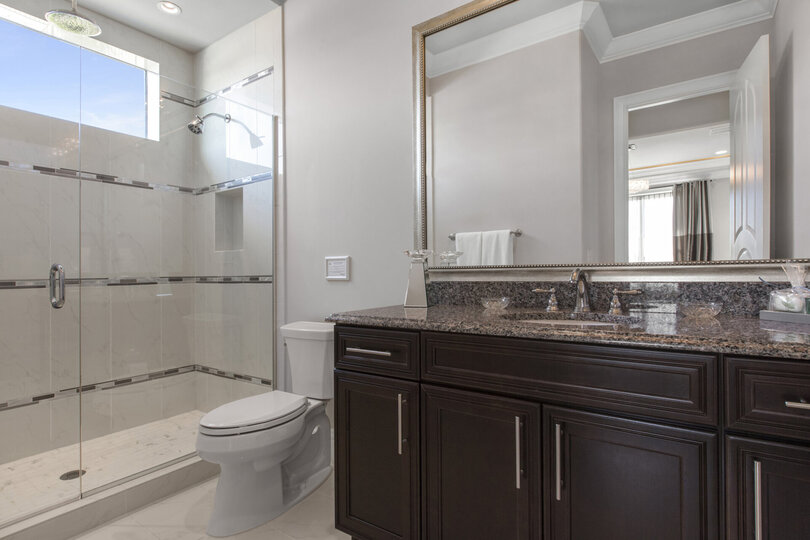 The en-suite bathroom features a glass walk-in shower