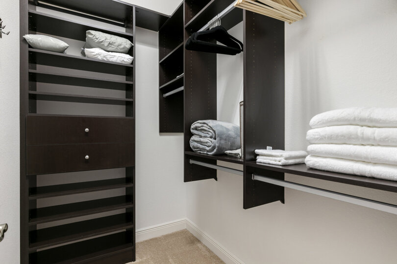 The master bedroom has a spacious walk-in closet