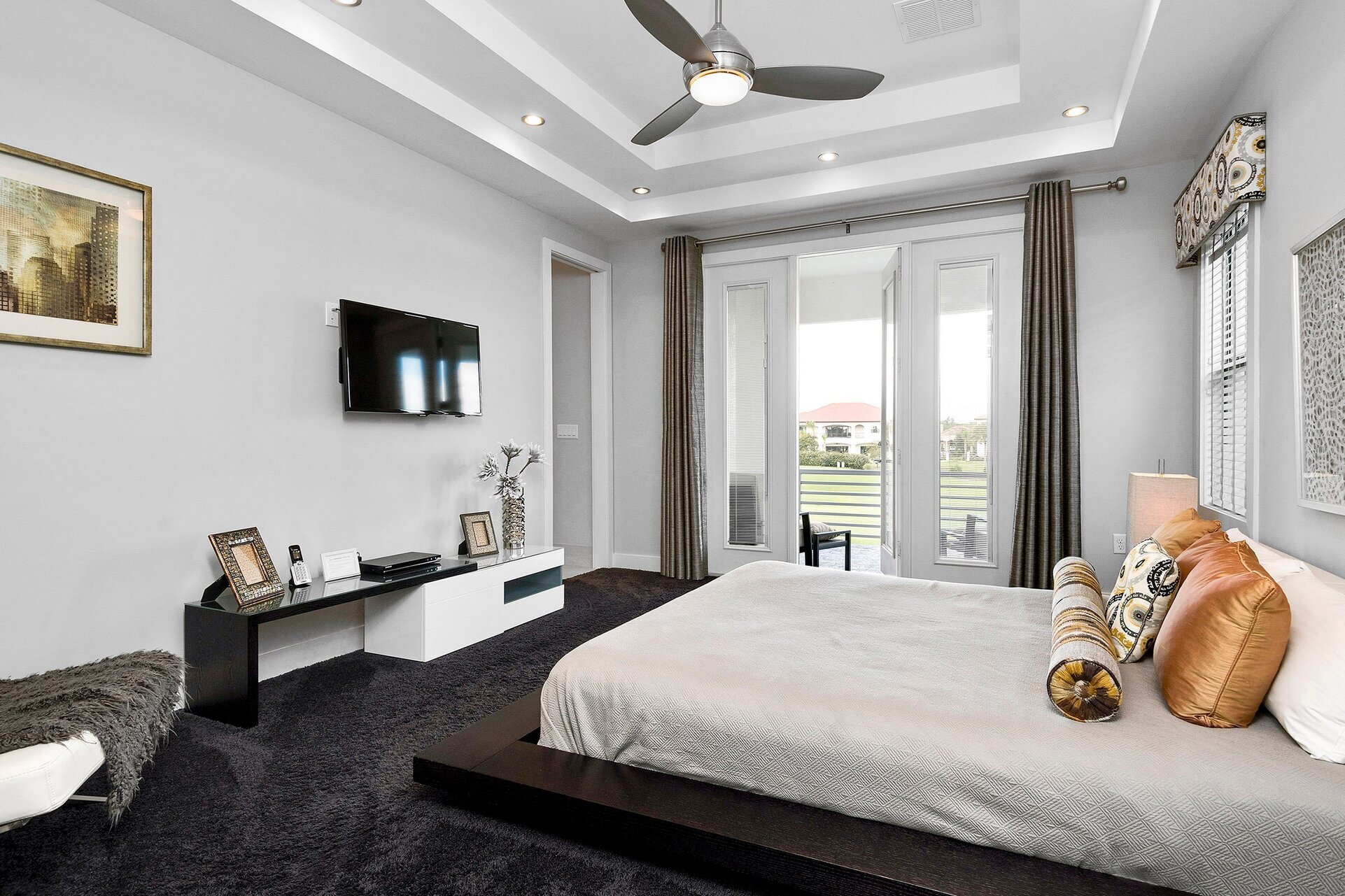 The master suite features a king bed, 40-inch TV, and access to private patio balcony
