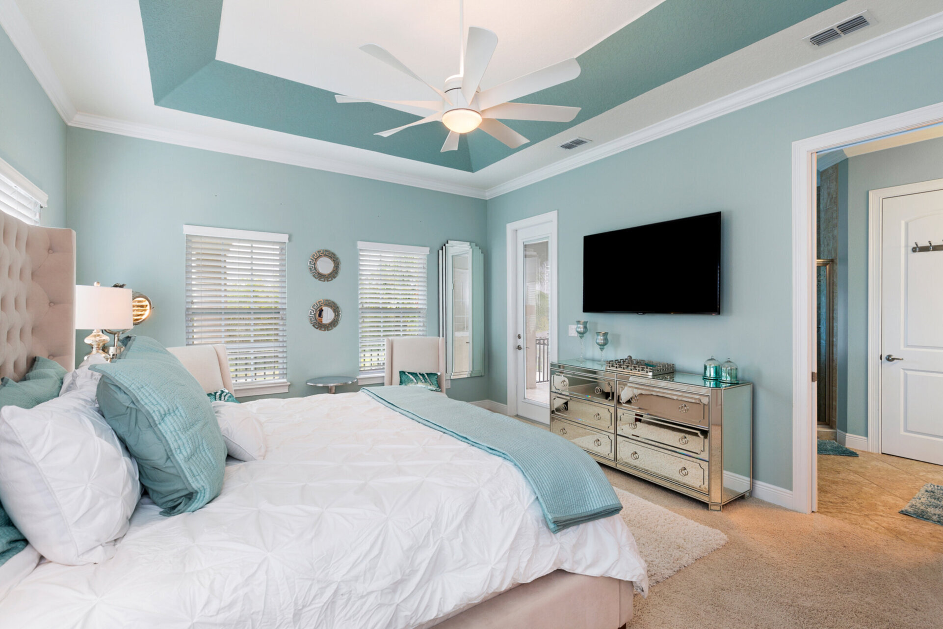 The master bedroom features a King size bed, en-suite bathroom, and private balcony with view to the pool area