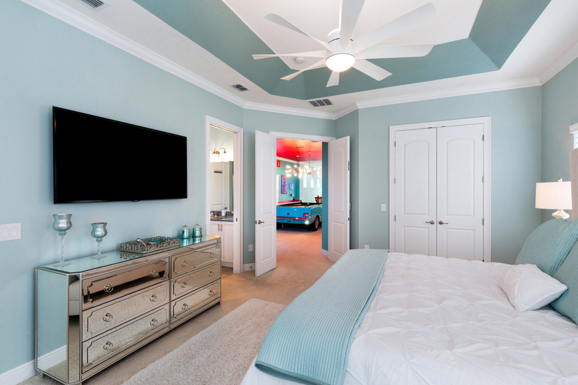 This bedroom has a 65 inch SMART TV