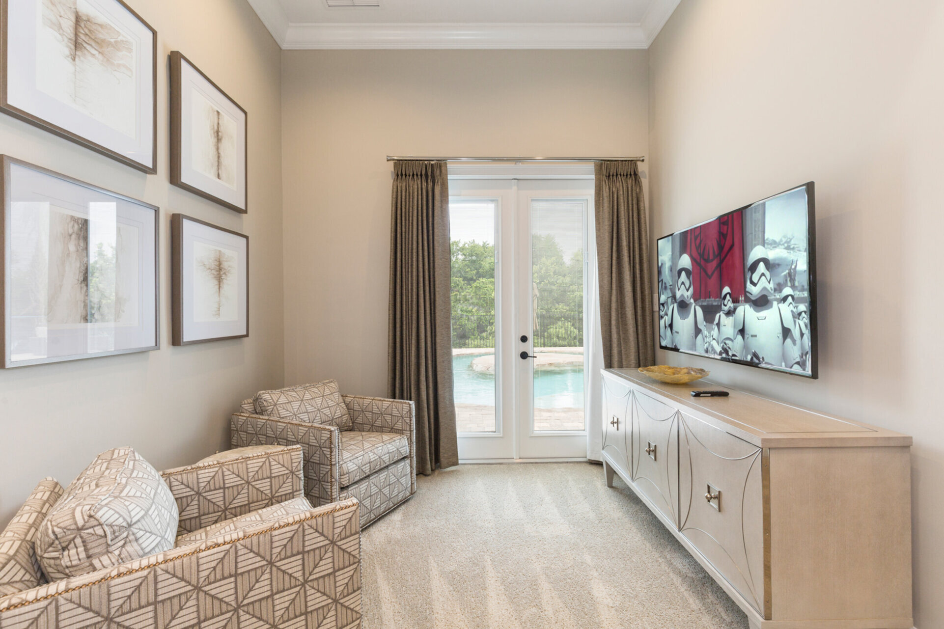 There is a seating area with 50-inch SMART TV and access to the pool area