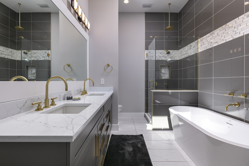 Ensuite bathroom with dual sink vanity, garden tub and walk-in shower