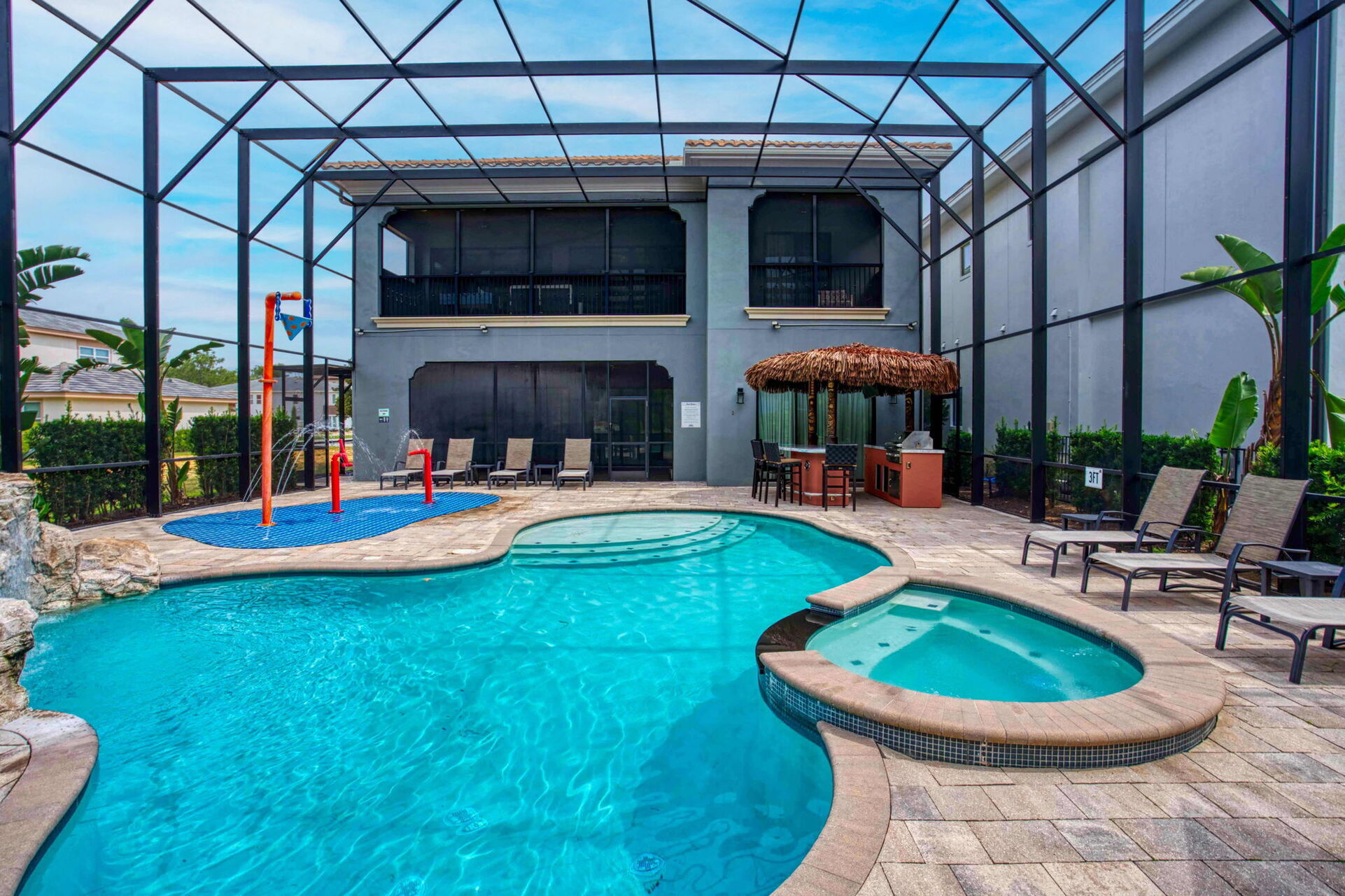The patio has a spillover spa, pool, waterfall, and splash pad