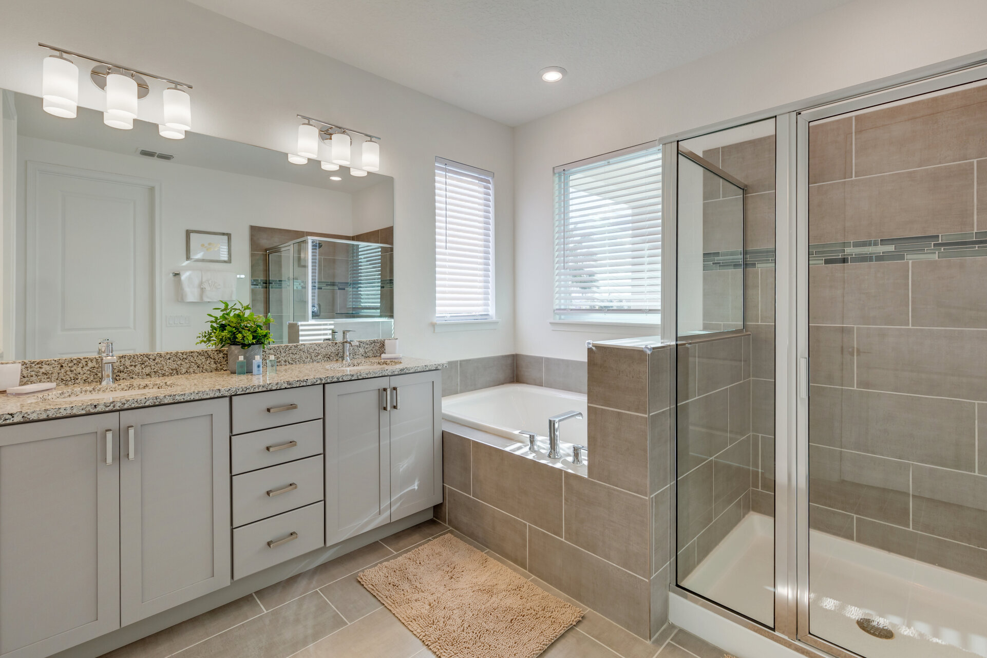 Beautiful ensuite bath has a dual vanity, walk-in shower and garden tub