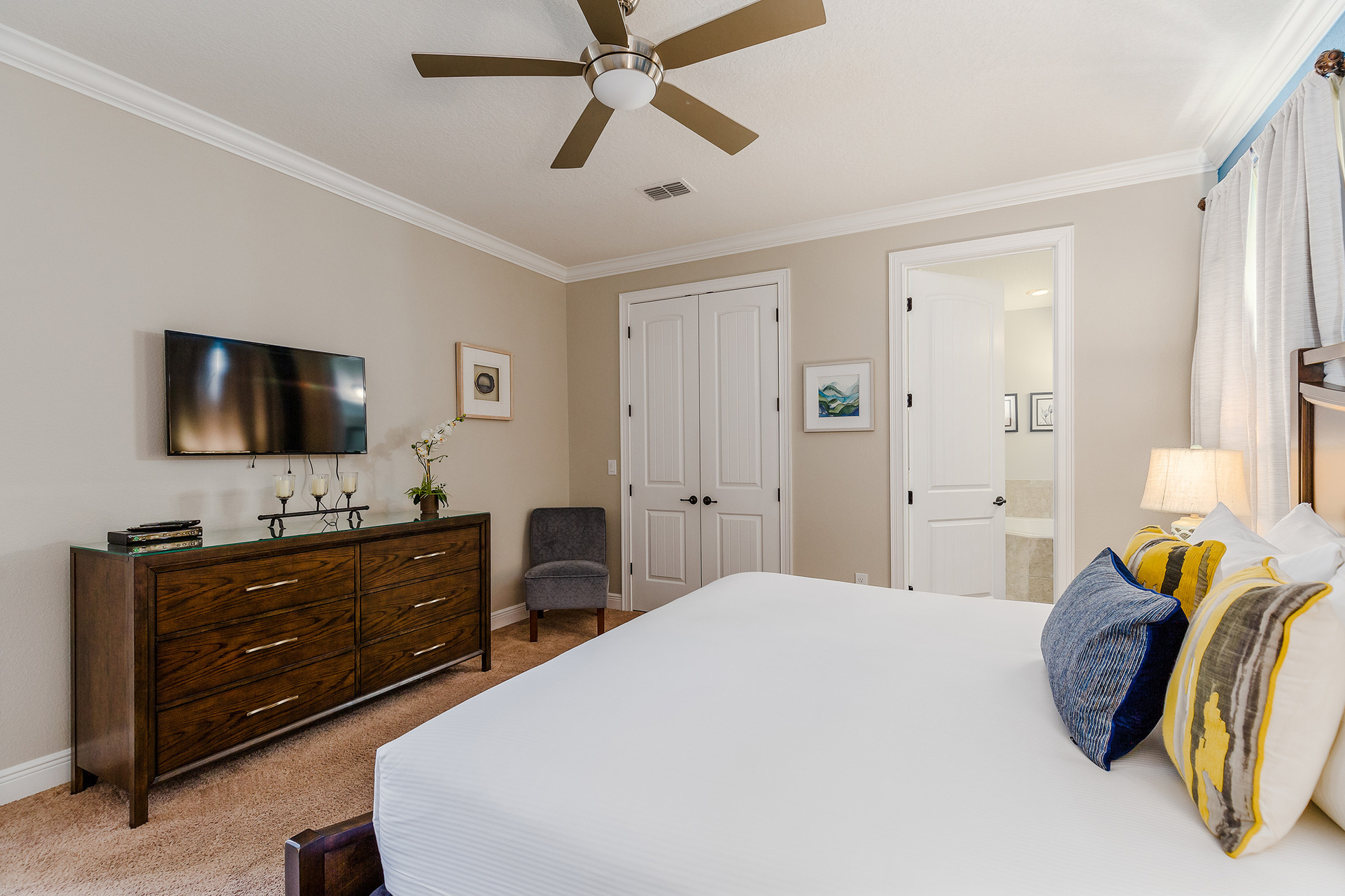 Spacious bedroom with a ceiling fan for optimal comfort