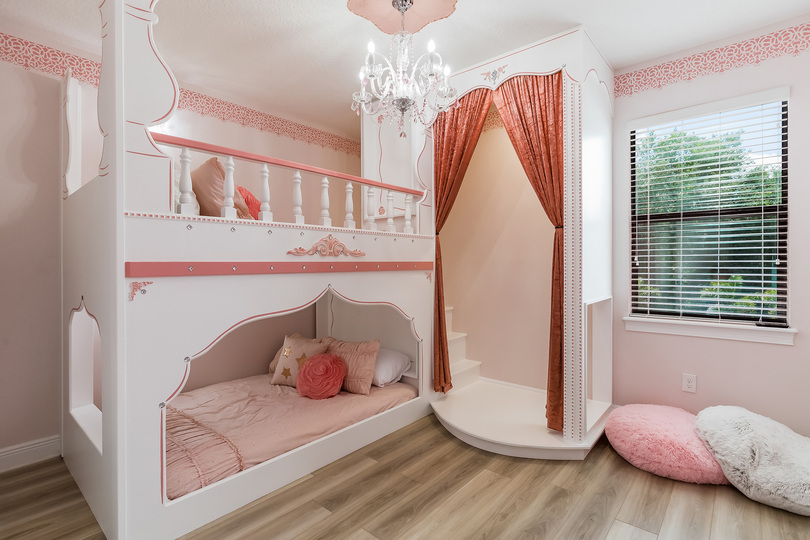 Princesses will enjoy their slumber in the Princess-themed bedroom furnished with two full-size bunked beds