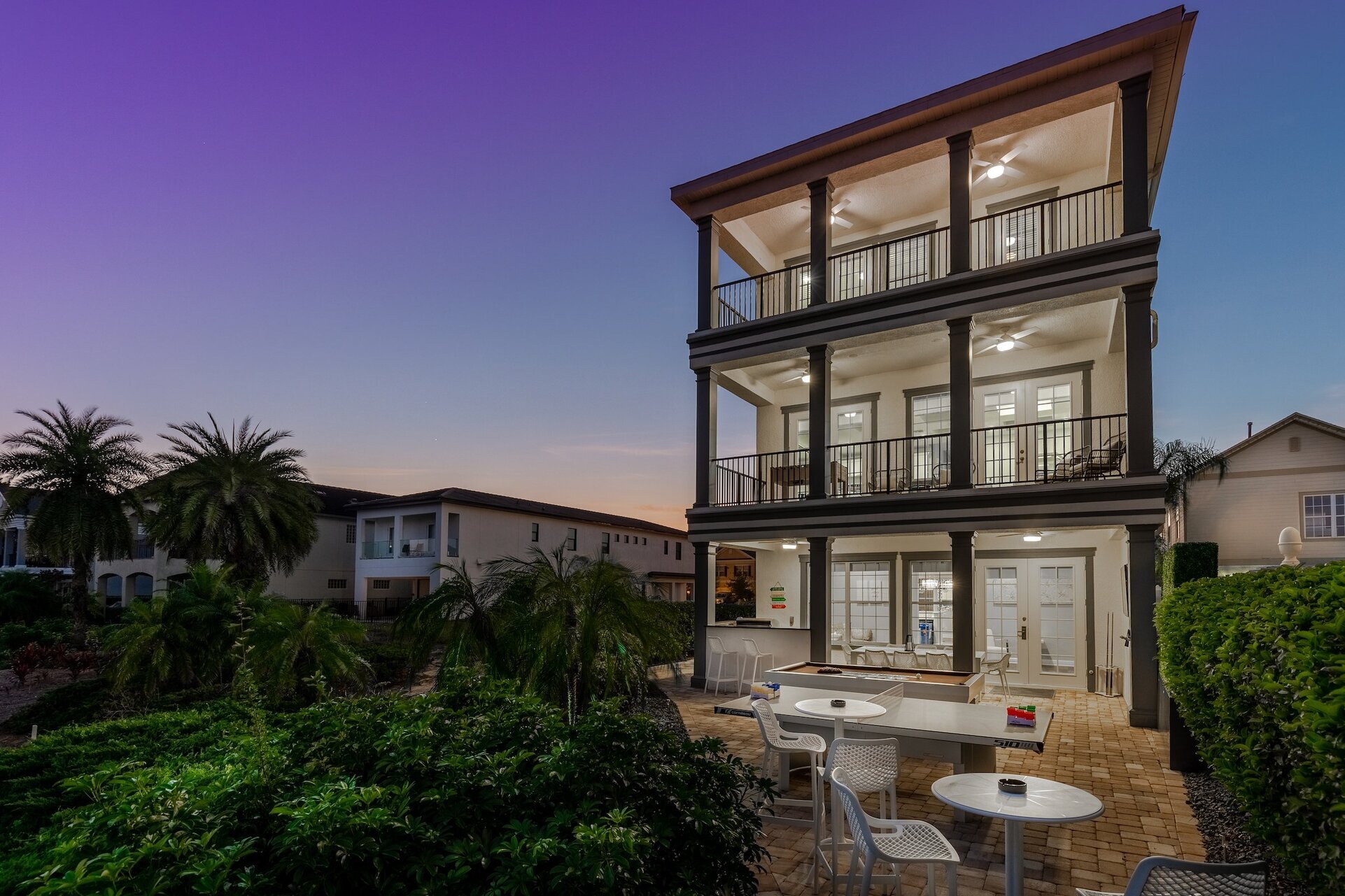 The back patio features slate pool table, ping pong table  outdoor TV and a summer kitchen with dining for 8 and bar seating for 2