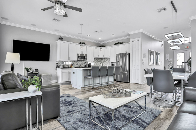 The open floor plan living area features modern furnishings and decor
