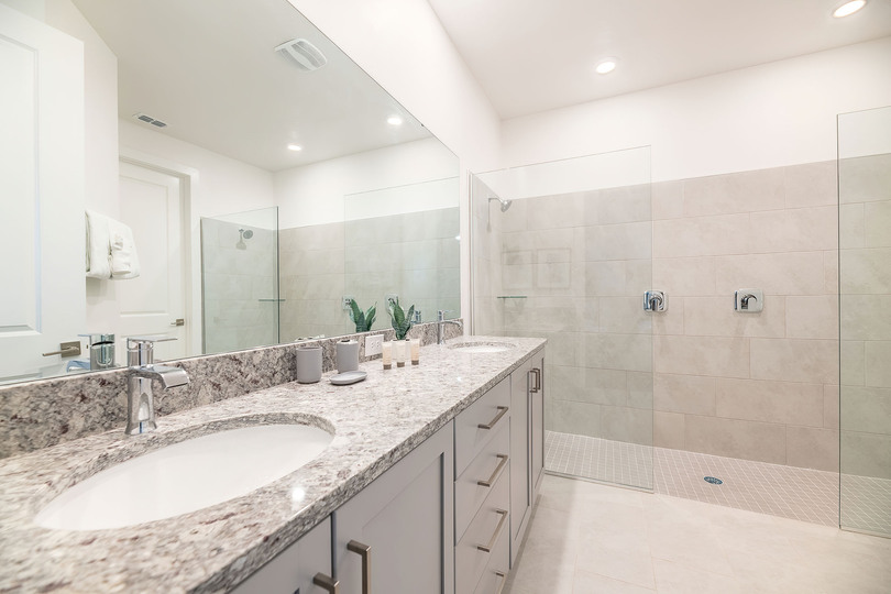 The en suite bathroom has a dual vanity and double shower