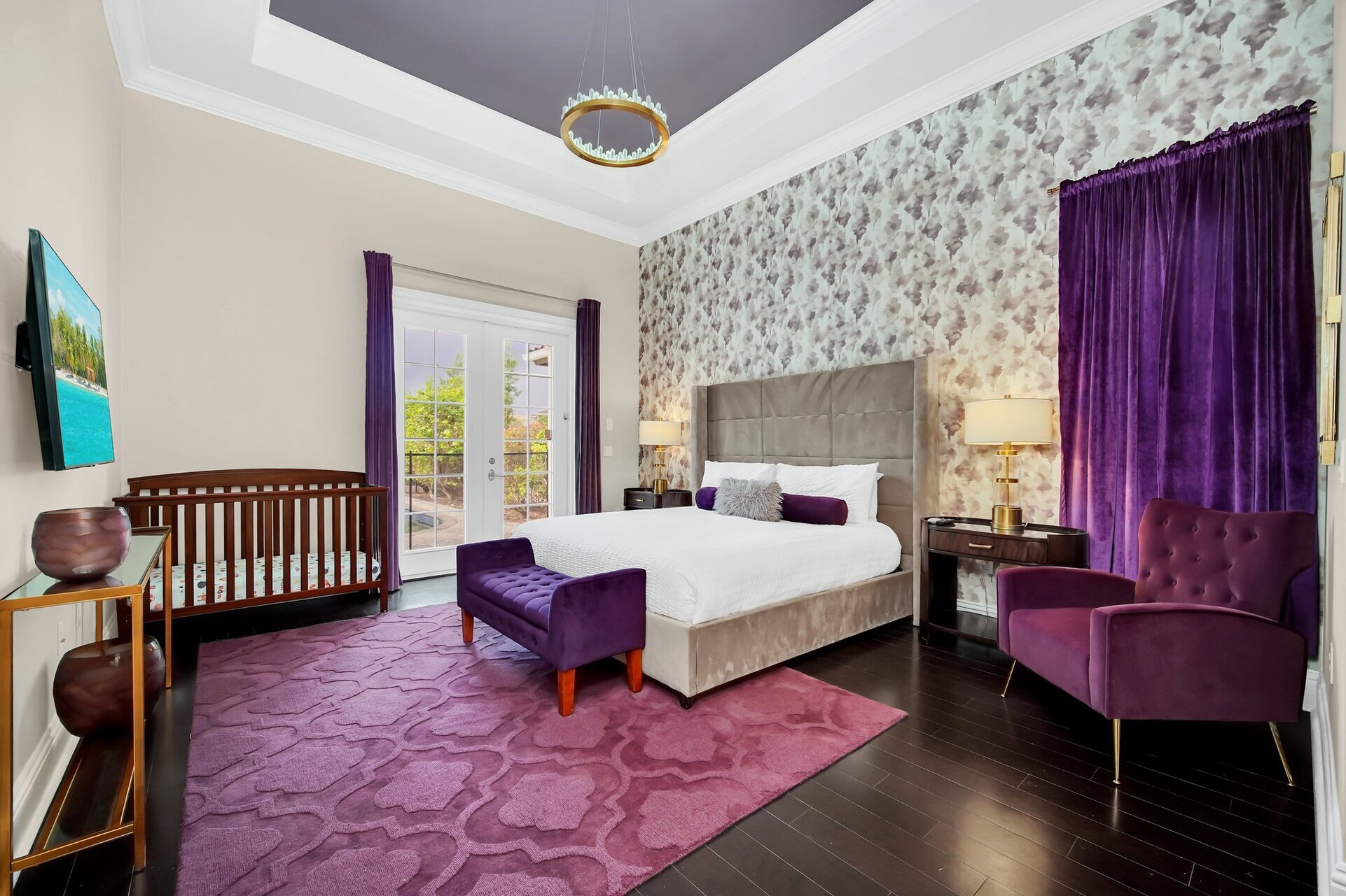 With its tranquil shades of purple, this bedroom offers a serene retreat, made even more inviting by its French door access to the outdoor area.
