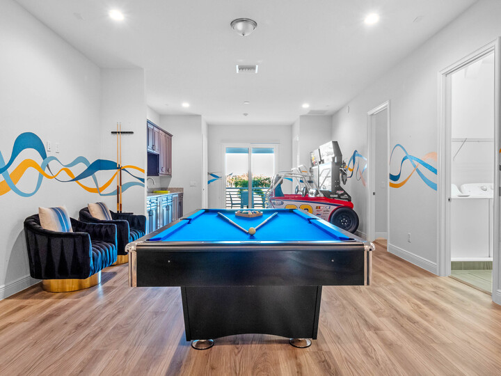 The open space on the second floor is a hub of entertainment, featuring a pool table, poker table, and arcade games, ensuring endless fun for everyone.
