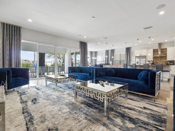 Sink into comfort in our spacious living room, where the serene blue hues of the couch effortlessly complement the plush carpet beneath your feet.