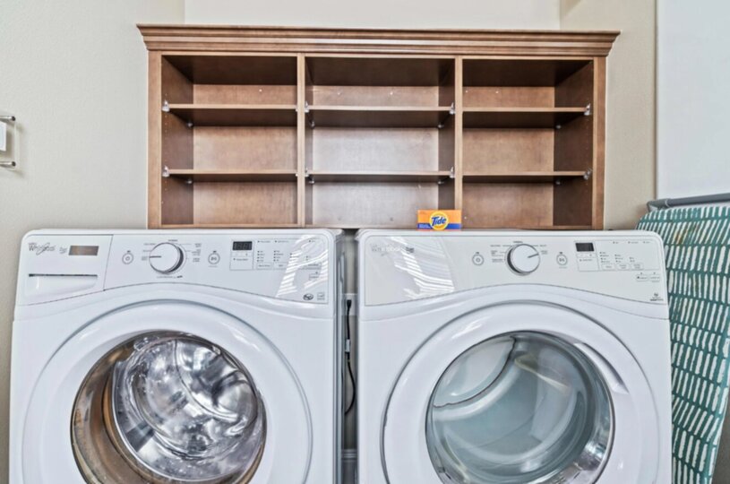 The first floor laundry room includes a washer and a dryer