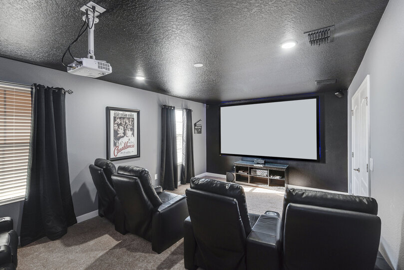 The theater seats 8 and has a 110-inch screen
