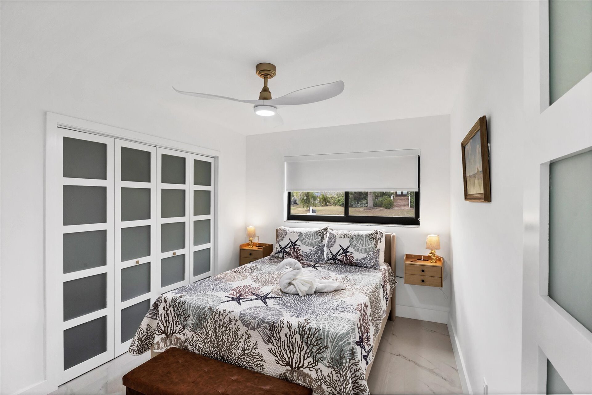 Queen bedroom with one queen bed and 24-inch Smart TV