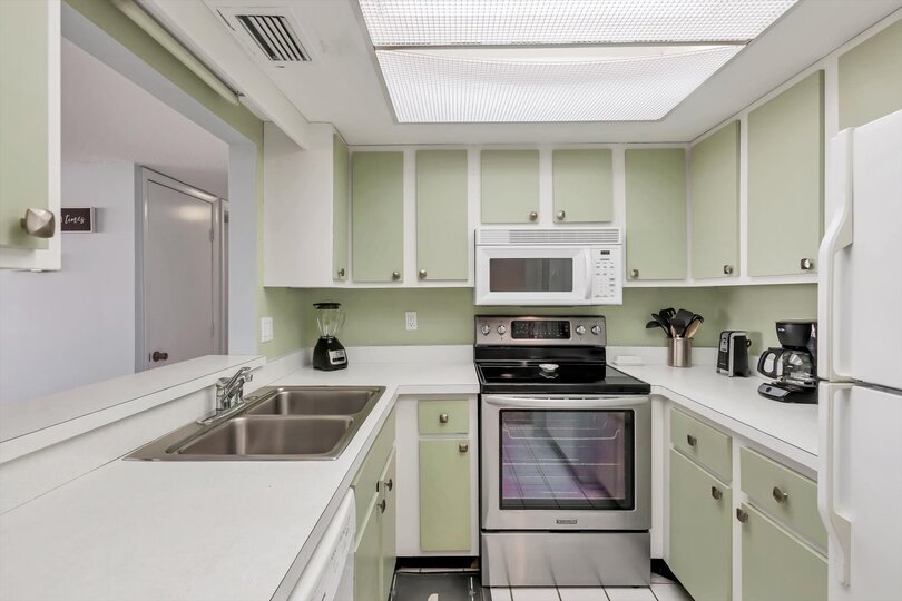 Fully-equipped kitchen overlooking living room/dining room