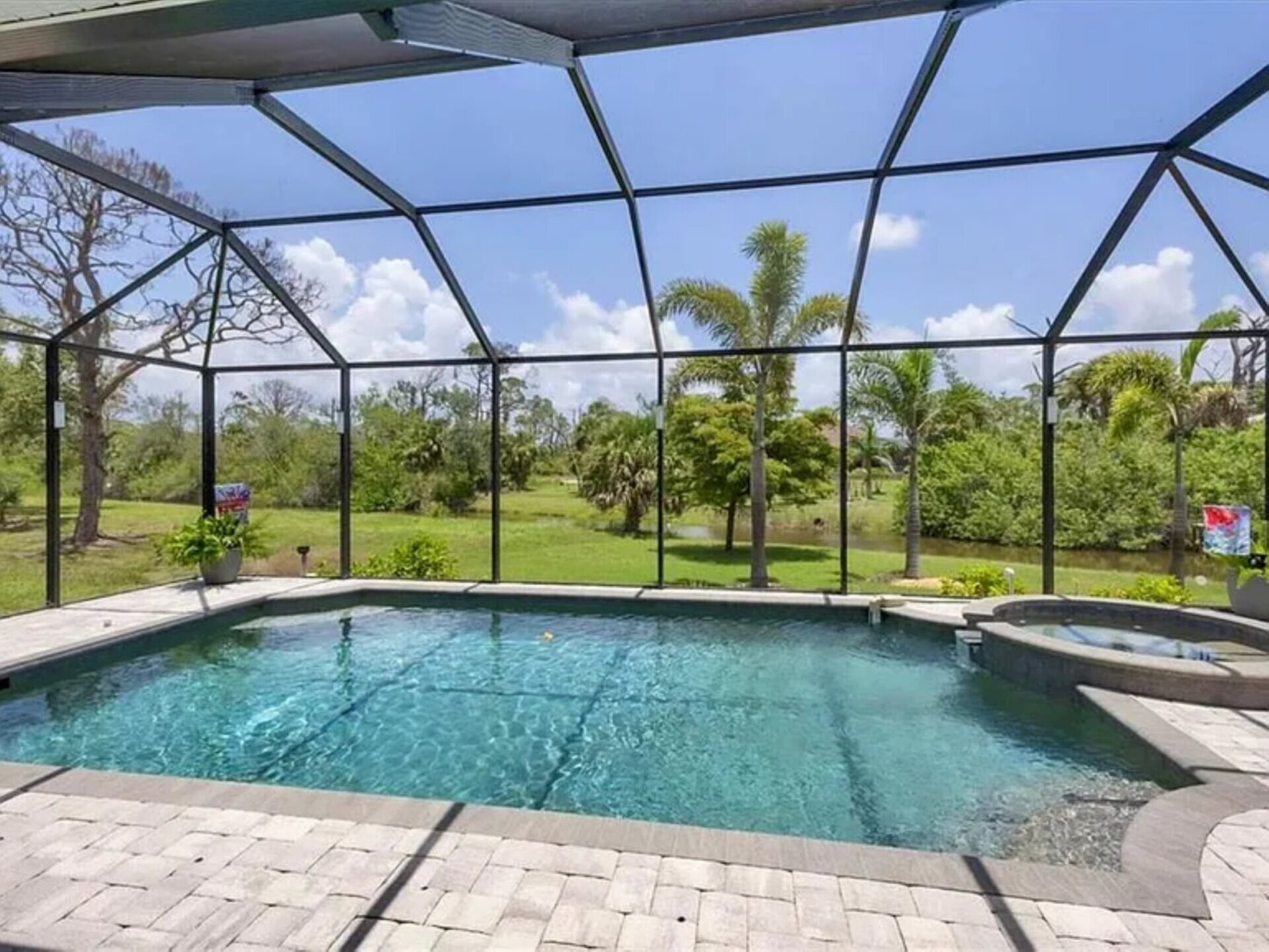 Sparkling pool & spa overlooking canal. Pool size: 22' x 14' x 6'. Spa seats 6