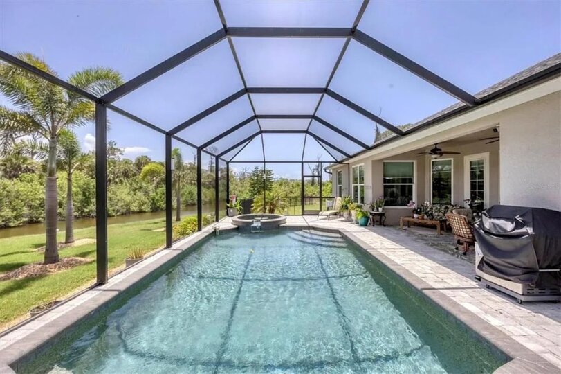Sparkling pool & spa overlooking canal. Pool size: 22' x 14' x 6'. Spa seats 6