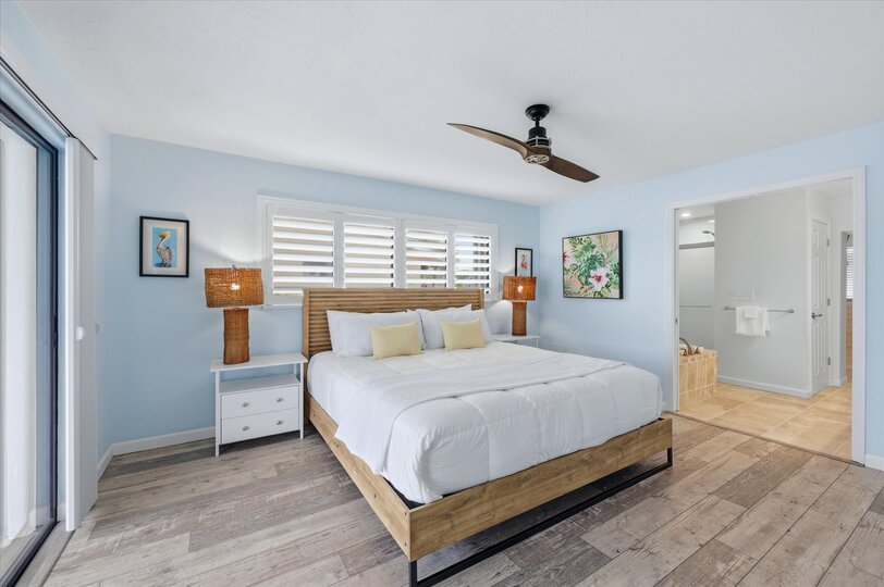 Bedroom 1 - Primary bedroom with king bed, attached bathroom, lanai access, and 43-inch Smart TV