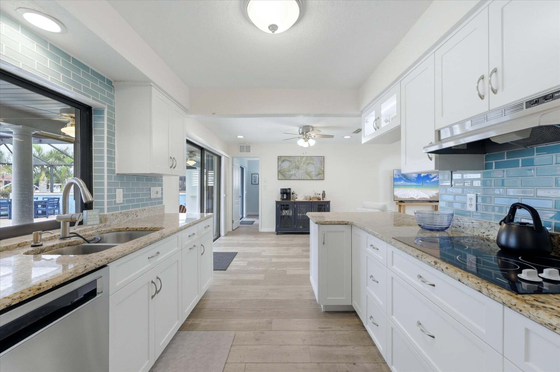 Bright, fully-equipped kitchen overlooking the pool and canal