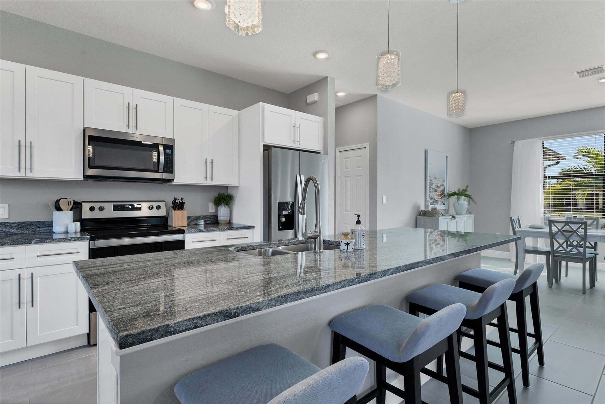Fully equipped kitchen overlooking living room and dining area