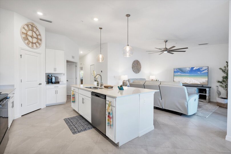 Fully-equipped kitchen over looking living room and dining area