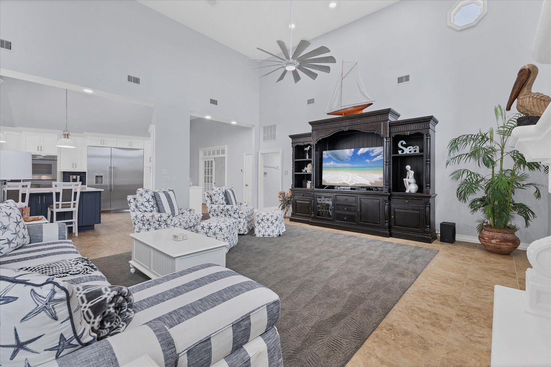 Large, open living space with ample seating, fireplace and 70-inch Smart TV