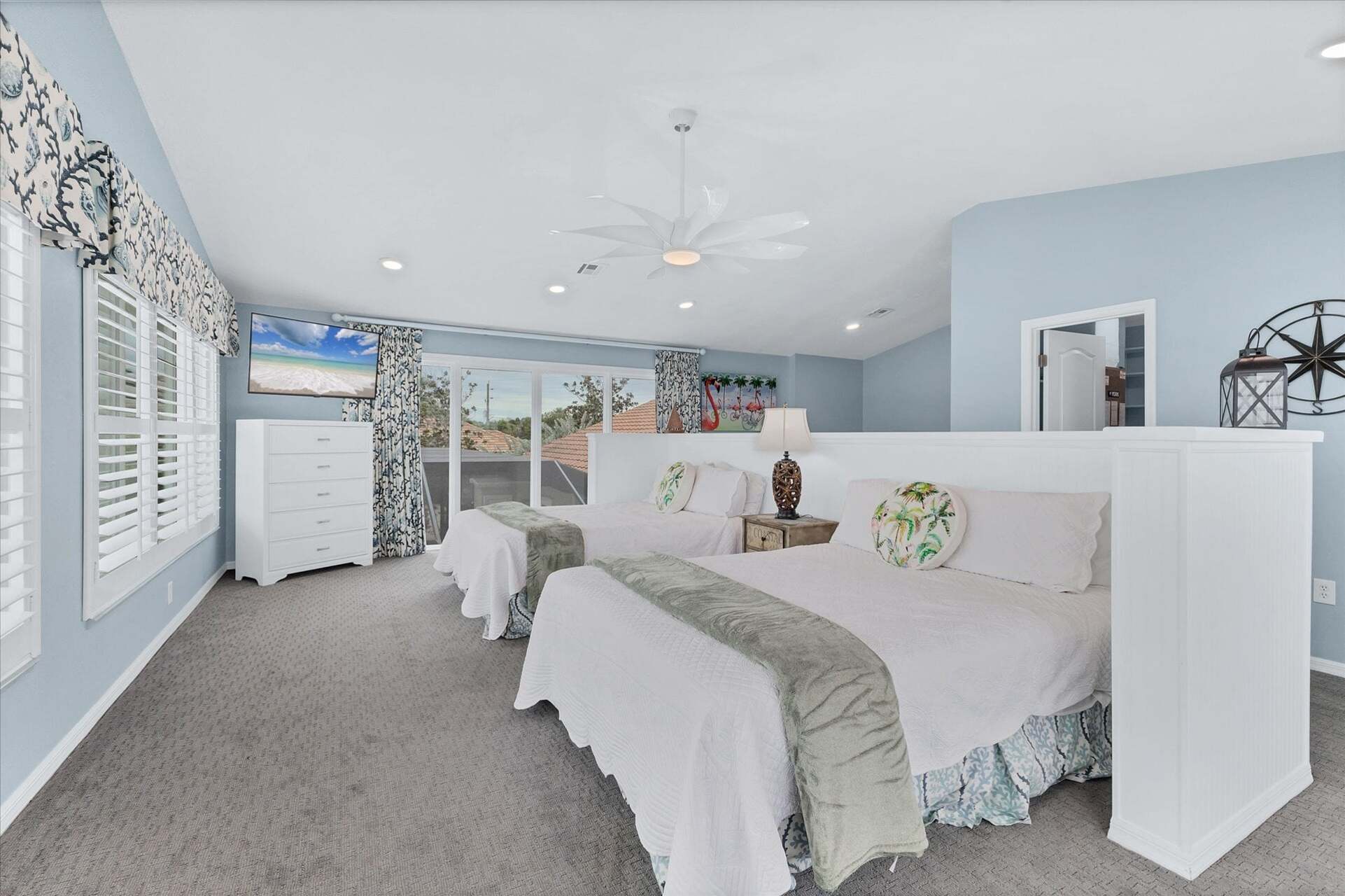 Upstairs guest bedroom features two queen beds, 50-inch Smart TV, attached bathroom, and 160 degree view of Lemon Bay