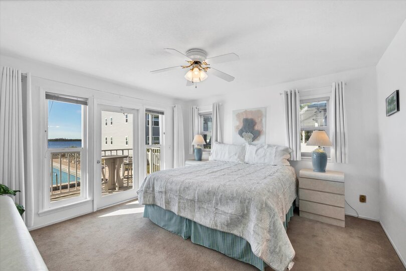 Primary bedroom with king bed, attached bathroom, balcony access and amazing water view