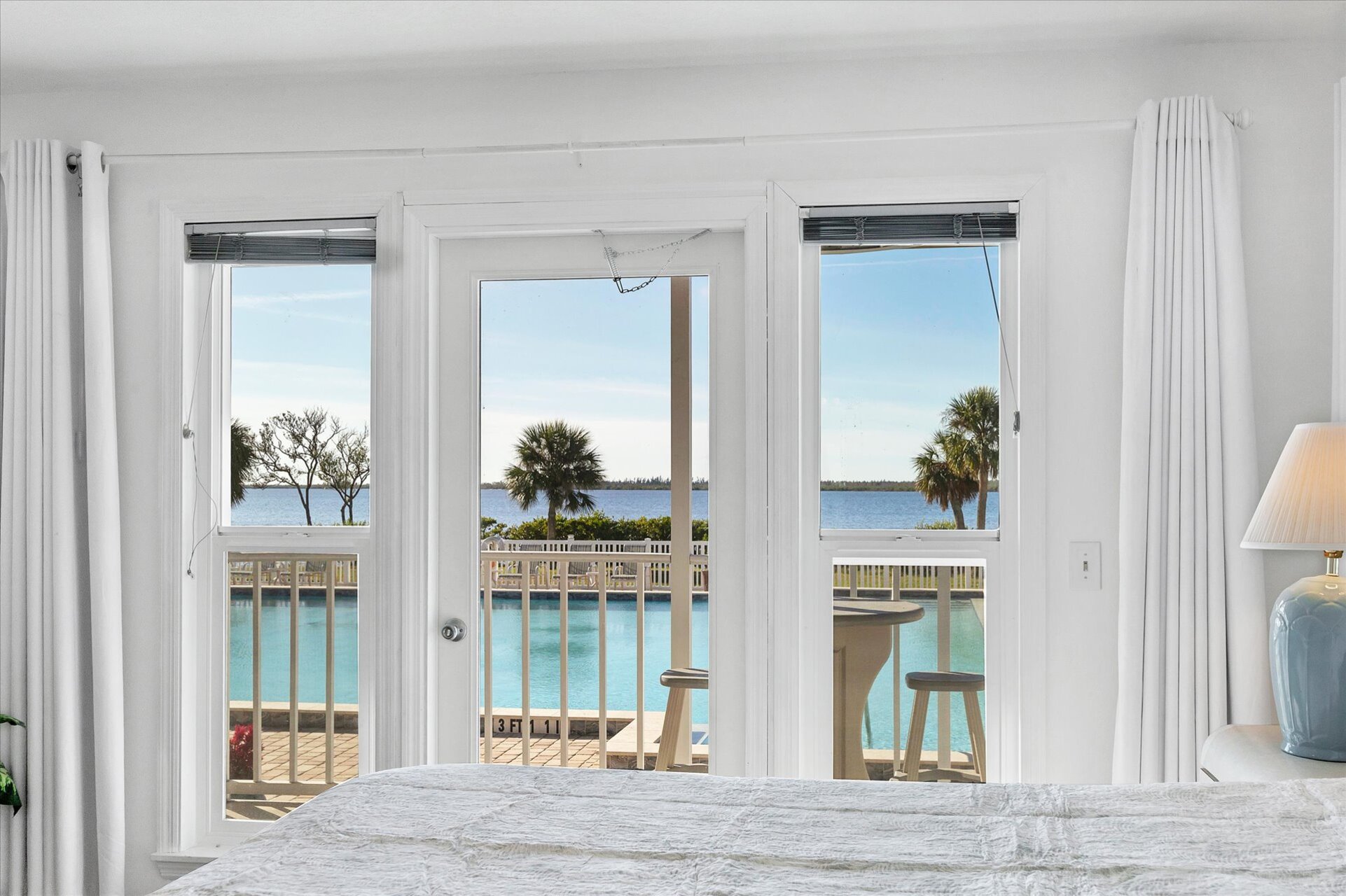 Primary bedroom with king bed, attached bathroom, balcony access and amazing water view